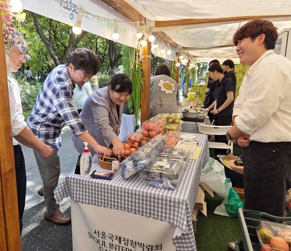 ▲최호영 산지유통국장(왼쪽에서 첫번째)과 서울시 대외협력과 관계자들(왼쪽에서 두번째,세번째)이 농협경제지주가 25일부터 이틀간 서울 동작구 보라매공원에서 운영한 '서울국제정원박람회 서로장터'현장에 방문했다./사진=농협경제지주
